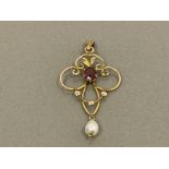 9CT GOLD ORNATE STONE SET PENDANT WITH OVAL RUBY STONE AND WITH PEARL DROP SETTING 1.4G