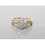 18CT YELLOW GOLD 7 STONE DIAMOND CLUSTER RING FEATURING 7 BRILLIANT ROUND CUT DIAMONDS CLAW SET