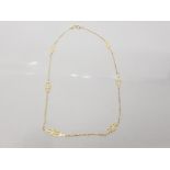 9CT YELLOW GOLD LADIES NECKLACE OF 6 INTER SPACED PIERCED DIAMOND SHAPED PANELS CONNECTED BY T