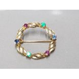 9CT YELLOW GOLD CIRCLE STONE SET BROOCH SET WITH 2 EMERALDS 2 RUBY'S AND 2 BLUE SAPPHIRES ALL THE