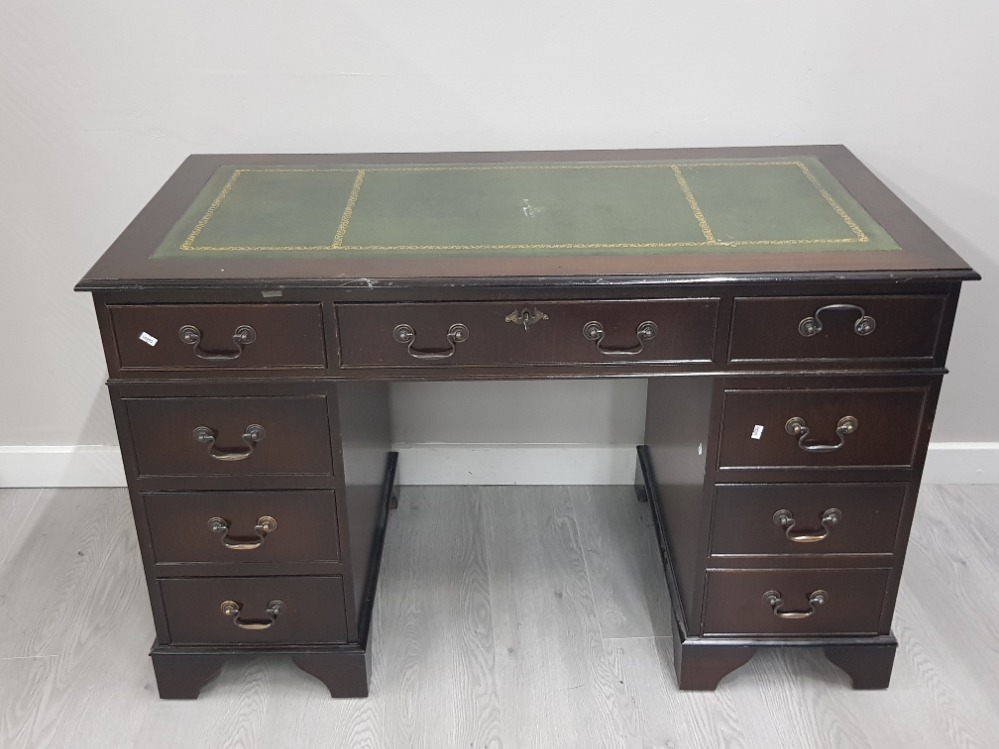 A REPRODUCTION MAHOGANY LEATHER TOPPED DESK