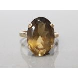 9CT YELLOW GOLD LADIES RING COMPRISING OF A OVAL SHAPED SMOKEY QUARTZ STONE SET IN FOUR CLAW SETTING