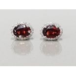 A PAIR OF 18CT WHITE GOLD GARNET AND DIAMOND CLUSTER EARRINGS 2.21CTS GROSS WEIGHT 2.5G