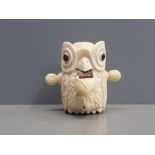 CARVED BONE TAPE MEASURE IN THE FORM OF AN OWL WITH A MOUSE IN ITS MOUTH