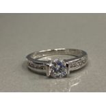 SILVER AND CZ SOLITAIRE WITH CZ SHOULDERS RING SIZE Q 2.9G GROSS