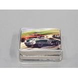 SILVER AND ENAMEL PILL BOX DEPICTING RACING CARS 21G GROSS