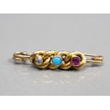 18CT YELLOW GOLD BROOCH SET WITH A WHITE STONE TURQUOISE STONE AND RUBY STONE IN A RUB OVER