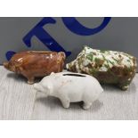 3 ANTIQUE PIGGY BANKS ONE WITH A SPLATTER GLAZE ONE WITH ROCKINGHAM GLAZE AND ONE WITH BISQUE