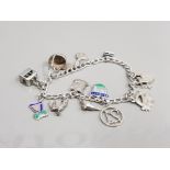 SILVER CHARM BRACELET WITH ASSORTED CHARMS AND PADLOCK CATCH 23.3G GROSS