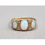 9CT YELLOW GOLD LADIES OPAL AND CUBIC ZIRCONIA RING FEATURING 3 OVAL SHAPED OPALS SET WITH 2 CUBIC