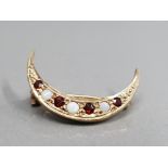 9CT YELLOW GOLD GARNET AND OPAL 1/2 MOON BROOCH FEATURING 4 GARNET STONES SET WITH A OPAL