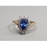 9CT YELLOW GOLD BLUE STONE AND CUBIC ZIRCONIA CLUSTER RING FEATURING A PEAR SHAPED BLUE STONE