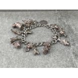 SILVER CURB BRACELET WITH 16 CHARMS 56.4G