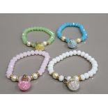 4 MULTI COLOURED BEAD BRACELETS WITH BALL CHARMS ATTACHED