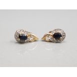 9CT YELLOW GOLD SAPPHIRE AND DIAMOND STUDS FEATURING BLACK SAPPHIRES SURROUNDED BY DIAMONDS