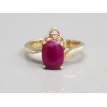14CT YELLOW GOLD RUBY AND DIAMOND ORNATE RING A OVAL SHAPED RUBY SET WITH TWO BRILLIANT ROUND CUT