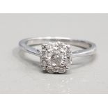 9CT WHITE GOLD DIAMOND CLUSTER RING FEATURING A DIAMOND SET IN THE CENTRE SURROUNDED BY EIGHT