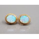 9CT YELLOW GOLD OPAL STUDS SET IN A RUB OVER SETTING WITH BEAD EDGING 3.2G GROSS
