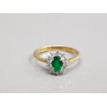 18CT YELLOW GOLD EMERALD AND DIAMOND CLUSTER RING COMPRISING OF A SINGLE OVAL EMERALD COMPLETE