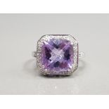 9CT WHITE GOLD AMETHYST AND DIAMOND CLUSTER RING FEATURING AN AMETHYST STONE IN THE CENTRE
