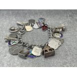 SILVER CURB CHARM BRACELET COMPLETE WITH 23 CHARMS 57.2G