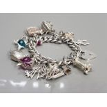 SILVER CHARM BRACELET WITH 16 ASSORTED CHARMS AND PADLOCK 99.1G GROSS