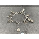 SILVER CHARM BRACELET WITH HEART PADLOCK AND 7 CHARMS 48G