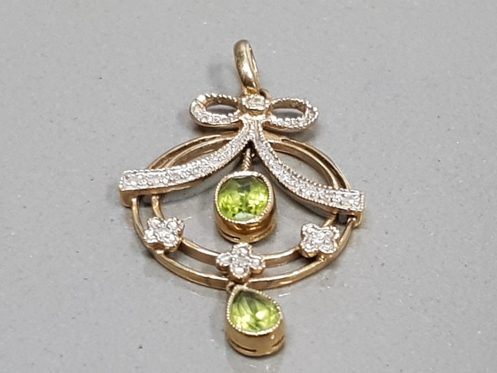 9CT YELLOW GOLD ORNATE PERIDOT AND DIAMOND PENDANT WITH A BOW STYLE CLUSTER OF DIAMONDS WITH TWO