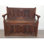 REPRODUCTION OAK SETTLE HIGHLY CARVED WITH STORAGE COMPARTMENT