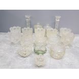 A BOX OF PRESSED GLASSWARE INCLUDES CANDLESTICKS LIDDED POTS ETC