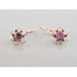 14CT YELLOW GOLD FLOWER DESIGN DROP EARRINGS FEATURING A FLOWER DESIGN SET WITH A PURPLE STONE IN