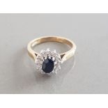 LADIES 9CT YELLOW GOLD SAPPHIRE AND DIAMOND CLUSTER RING FEATURING A SINGLE OVAL SAPPHIRE SURROUNDED