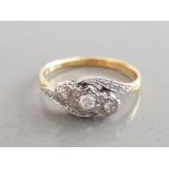 LADIES 18CT AND PLATINUM THREE STONE DIAMOND TWIST RING WITH THREE ROUND CUT DIAMONDS SET IN A TWIST