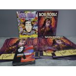 A collection of signed Ross Noble posters 2 magazines and DVD etc