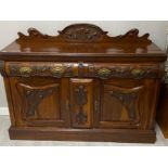 Heavily carved mahogany sideboard with brass mounted handles