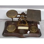 Ornate set of brass letter or sovereign scales on wood base includes small set of brass weights