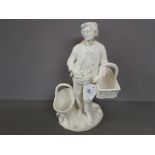 Large white glazed unsigned figure of a french peasant carrying a basket with another basket by