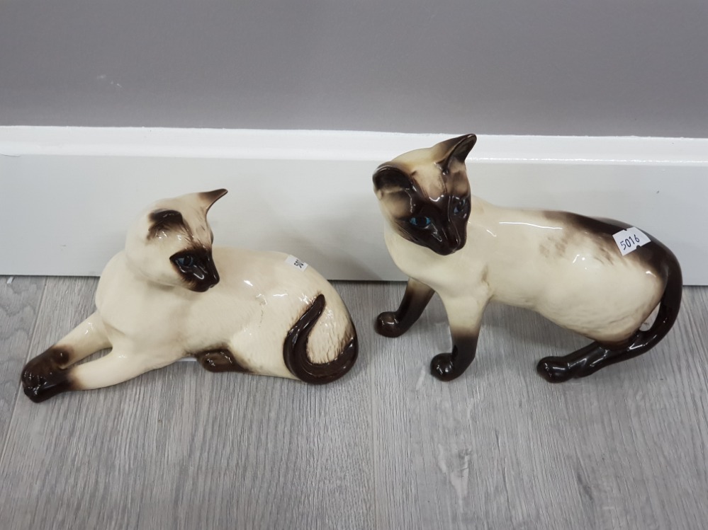 Beswick standing siamese cat together with a lying royal doulton siamese cat in great condition