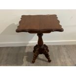 Antique mahogany games table with flip and twist serpentine top, on heavily carved pedestal base