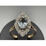 Antique 9ct gold aquamarine and diamond cluster ring. Comprising of a oval shape aquamarine set in a