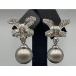 13mm natural grey pearl and diamond fancy bow earrings. Over 1.5cts of D colour VS clarity diamonds
