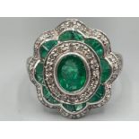18ct white gold Emerald and diamond cluster ring. Comprising of 17 emerald stones and 34 diamonds