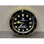 Gold and black wall clock in the style of Rolex submariner