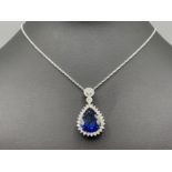 Large pear shaped blue sapphire and diamond pendant and earring set in 18ct white gold approx
