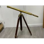 Large brass telescope on wooden tripod stand