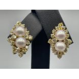 14ct gold diamond and pearl cluster studs comprising of two pearls complete with cluster of eighteen