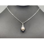 Natural Tahitian pearl pendant set with diamonds and a blue sapphire cabochon in 18ct white gold 8.