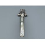 Silver babies rattle in the form of an owl with mother of pearl handle