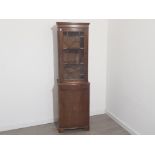 Tall narrow 1930s display cabinet, with glazed display top section and storage cupboard below,