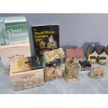 Box containing miscellaneous cottage ornaments includes 2 david winter cottages and collector books